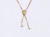 a close up of a necklace on a white surface