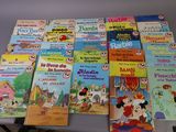 many children ' s books on a table with a white table cloth