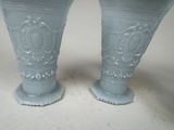 two vases that are sitting on a table