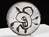 a plate with a drawing on it sitting on a table