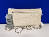 a white purse with a chain around it on a table