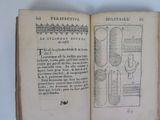 an open book with a drawing of a microscope and other items