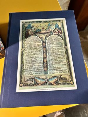 an open book sitting on top of a table next to a yellow table