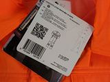 an orange jacket with a tag attached to the back of it