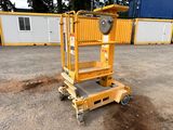 a close up of a yellow lift truck parked in front of a building