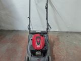 a lawn mower that is sitting in a garage