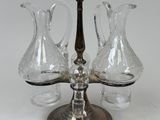 three glass vases sitting on a metal stand