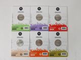 four different types of coins are in a package on a white surface