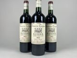 three bottles of wine sitting on top of a table next to each other
