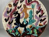 a decorative plate with a woman and a horse on it
