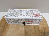 a white box with a drawing on it sitting on a table
