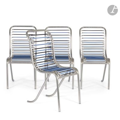 three metal chairs with blue cushions sit side by side on a white surface