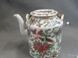 a tea pot with a bird on it on a table