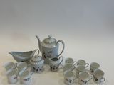 a lot of cups and saucers sitting on a table