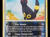 La carte Pokémon représente un chat noir et jaune.