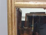 a mirror that has a picture of a boat in it