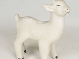 a small white animal figurine on a white surface