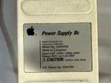 an apple power supply attached to an apple computer