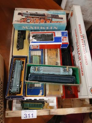 a lot of toy trains in a box on a table
