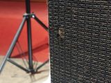 a close up of a speaker on a stand in a room