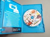 a wii game in a blue case on a table