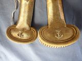 two gold plate holders on a blue table cloth