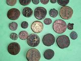 several different types of coins on a green surface