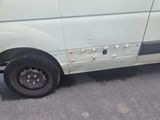 a white van that has been vandalized and is parked on the street