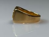 a gold ring that is sitting on a white surface