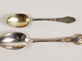 two spoons sitting next to each other on a table