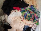 a pile of clothes on a bed in a room