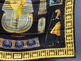 an image of a scarf with egyptian symbols on it hanging from a wall