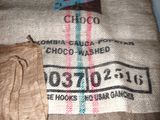a bag of coffee sitting on a table next to a bag of coffee