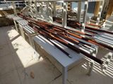 a long table with a bunch of baseball bats on it
