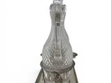 silver plated glass decanter on stand on white background