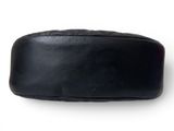 a black bag that is sitting on a white surface