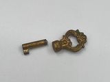 a close up of a small key and a small key on a white surface