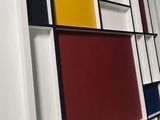 brightly colored bookshelves in a room with white walls and black trim