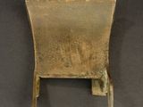 an old metal chair on a black surface with a black background