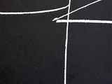 black and white photograph of a cross drawn in chalk on a blackboard
