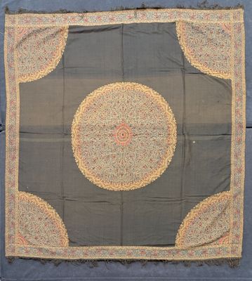a blue and yellow rug with a circular design on it