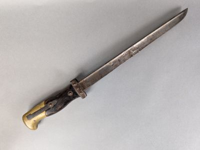 a close up of a knife on a table with a white background