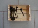 several spoons and spoon spoons in a wooden box on a tile floor