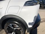a close up of a tire on a car in a parking lot