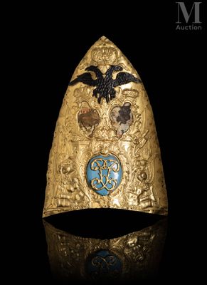 a close up of a gold ring with a bird on it