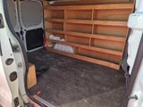 a white van with a wooden shelf in the back of it