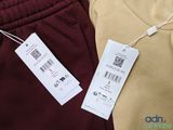 two men ' s pants with a price tag on them sitting next to each other