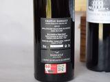 two bottles of wine sitting next to each other on a table
