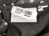 a label on the back of a polka dot dress