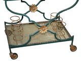 a metal and glass bar cart with flowers on it